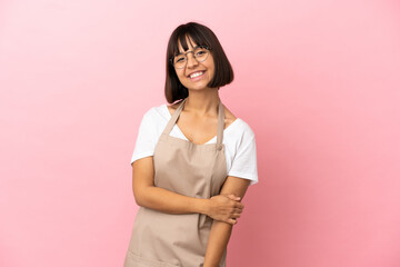 Restaurant waiter over isolated pink background laughing