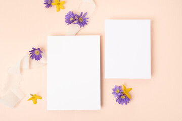 Fresh flower stationery flat lay with two blank cards on blush background