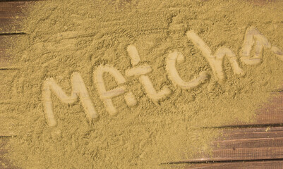 powder with words matcha tea on tea background