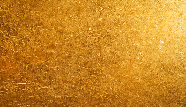 Shiny gold background made of rough textured gold paper.
