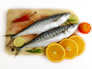 Fresh Seer Fish,King Fish decorated with herbs and vegetables on a wooden pad,Selective Focus.