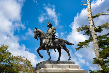 Date Masamune Monument at Aoba Castle, Sendai City, Miyagi Prefecture, Japan, in the daytime the background is blue sky and clouds.