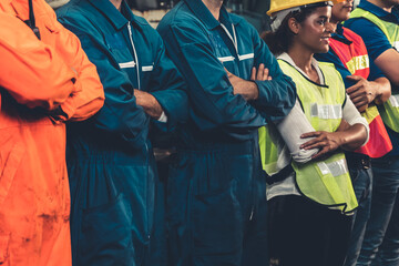 Skillful worker stand together showing teamwork in the factory . Industrial people and...