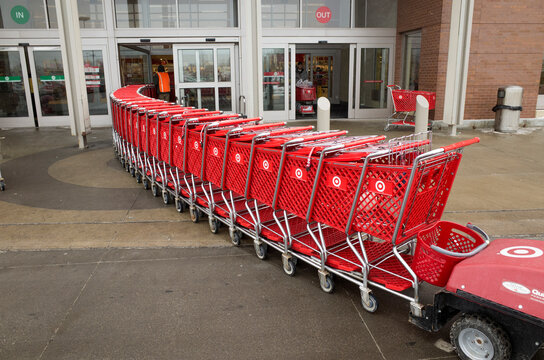 Line Up Of Shopping Carts Being Pushed Into Target With Remote Electronic Cart Pusher By The Cart Boy. St Paul Minnesota MN USA