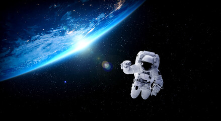Astronaut spaceman do spacewalk while working for space station in outer space . Astronaut wear full spacesuit for space operation . Elements of this image furnished by NASA space astronaut photos. - obrazy, fototapety, plakaty
