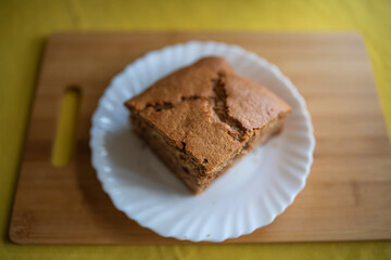 A piece of homemade marble cake on a wooden cutting board, close-up.