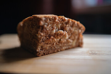 A piece of homemade marble cake on a wooden cutting board, close-up.
