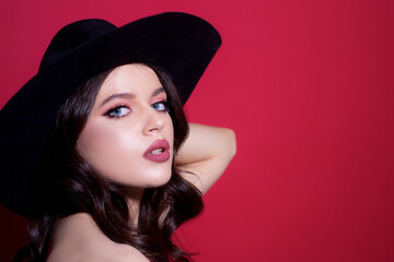 Fashion style portrait of trendy girl in black hat. Elegant lady. Sensual woman vogue.