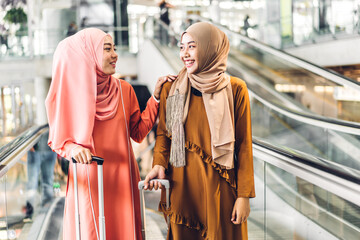 Fototapeta premium Two young beauty islamic asian arabic muslim woman wearing a hijab enjoying shopping and having fun talking together in the shop at fashion store