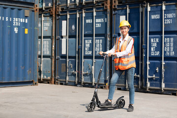 woman engineer riding electric scooter in containers warehouse storage © offsuperphoto