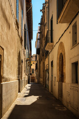 Fototapeta na wymiar Narrow streets in Palma city on Mallorca island in Spain on a sunny summer day