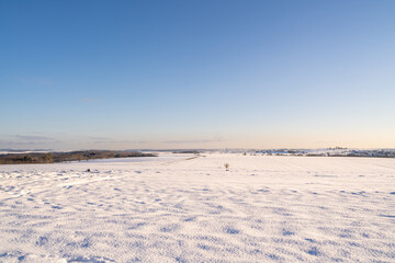 Fototapeta na wymiar Winter landscape with snow and blue sky 