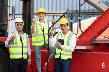 factory workers or engineer team raise hands pose for successful job in containers warehouse storage