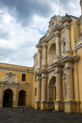 Obraz premium facade of an old yellow and white church with classical architecture in a colonial old town in the middle of a bright sunny morning