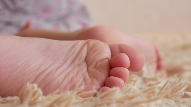 Close-up of the feet of a little boy lying on a soft fleecy blanket