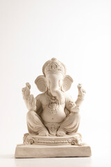 Statue of Lord Ganesha Made from plaster of Paris without color on white background.