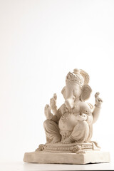 Statue of Lord Ganesha Made from plaster of Paris without color on white background.