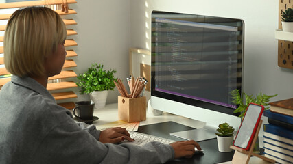 Side view young female programmers working on new project at the office.