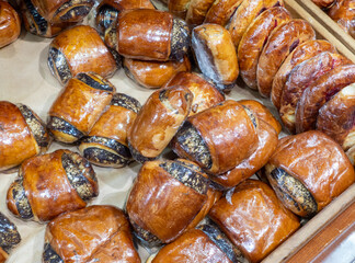 Assortment of delicious freshly baked sweet and pastry for sale on counter of shop, grocery, market, cafe or bakery