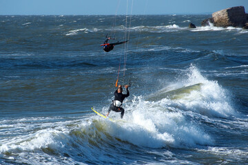 The kitesurfer  cuts the wave of the Baltic Sea.