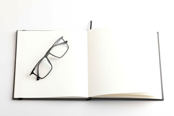 Spectacles or eyeglasses and diary on white background