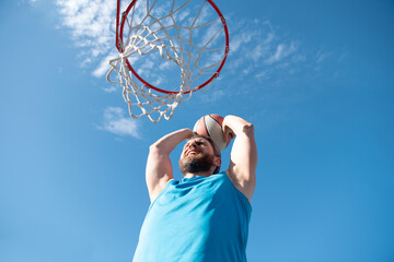 Basketball concept. Man jumping and making a slam dunk playing streetball, basketball. Urban...