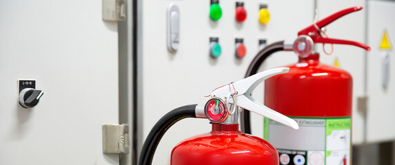 Fire extinguisher, Close-up red fire extinguishers tank with door exit in the building concepts of protection and prevent for emergency and safety rescue and fire training.
