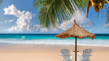 Straw umbrella and beach chairs under palm trees and turquoise sea in tropical island. Fashion travel and tropical beach concept.
