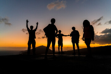 Fototapeta na wymiar People stand at the top of a hike