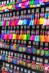 Fototapeta na wymiar Handmade Souvenir Earring Asian style are hung and display for sales in the shop