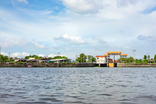 Chao Phraya River in the open sky day with the village, temple and local building. Shoot it in the boat from the middle of river.