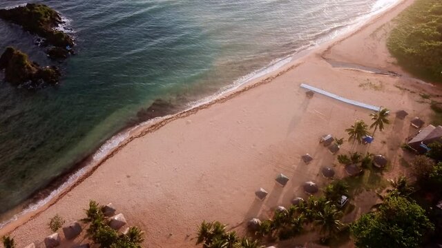Aerial View Of Idyllic Beach With Huts At Shore During Sunny Day - Catanduanes, Philippines