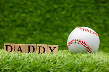 Baseball Father's day with baseball and DADDY word are on green grass background
