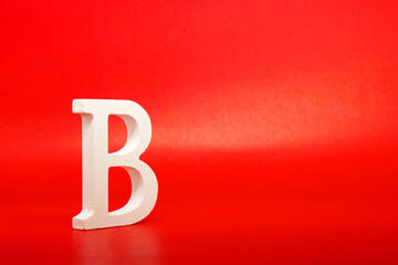 B white letter word wooden Isolated Red Background with Copy Space - Advertise object symbol or the second grade competition Concept 
