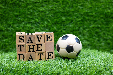 Soccer ball with save the Date are on green grass for Party Invitation