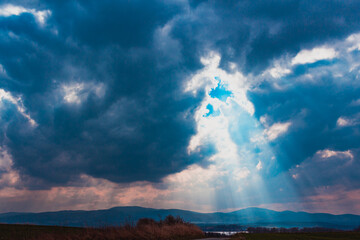 Cloudy sky above the road near mountains