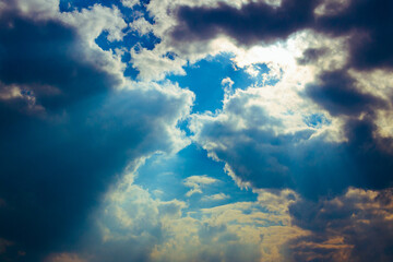 Cloudy sky with points of translucent sun rays