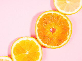 Colorful orange citrus slice fruit texture background on pastel pink