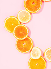 Colorful orange citrus slice fruit texture background on pastel pink