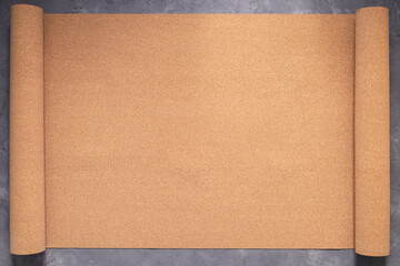 Roll of cork at concrete floor background texture. Corkboard at wall background