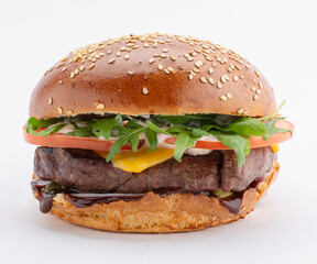 Delicious burger with juicy beef steak, melted cheese and arugula with tomato, on a white background. Template for the designer.