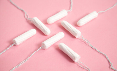 Menstrual tampon on a pink background.