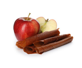 Delicious fruit leather rolls and apples on white background