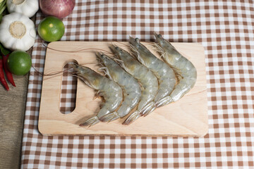 fresh shrimps on wooden cutting board plate. fresh shrimp prawns for cooking