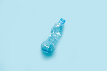 used plastic bottle on a blue background. The concept of using plastic. Top view, flat lay