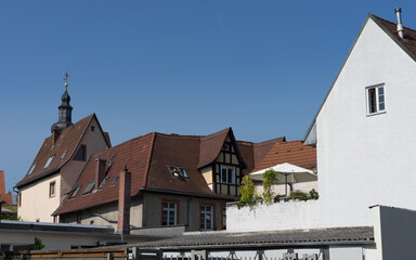 Holiday at home: white parasol on a roof terrace in front of old half-timbered houses