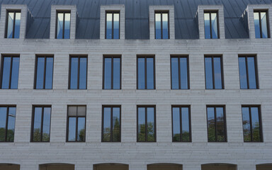 Karlsruhe, Germany - Sept. 11, 2020: closeup of the modern stone glass facade of a business...