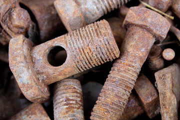 Old rusty bolts and nuts. Fasteners on the trash can.