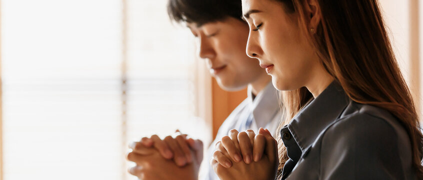 Asian women and men are doing dua to remembering the teachings of Jesus And confess your sins before God. It's faith and respect According to the beliefs of Christ's religion. Concept faith believe.