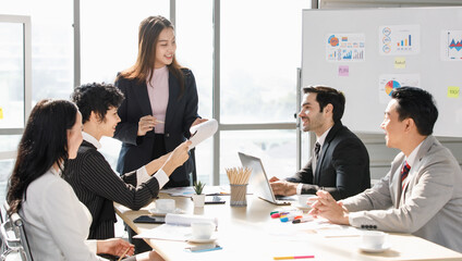 A Group of diverse businesspeople, Asan and Caucasian, make a conference together at the desk. Idea for good team at workplace